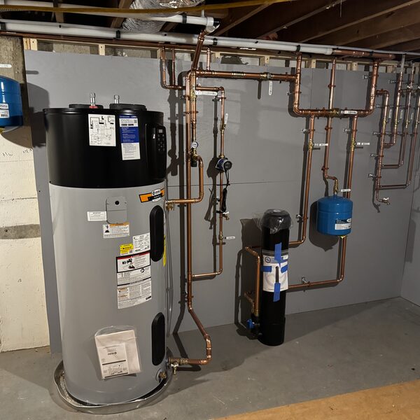 Heat pump water heater with a full copper repipe and water treatment tank